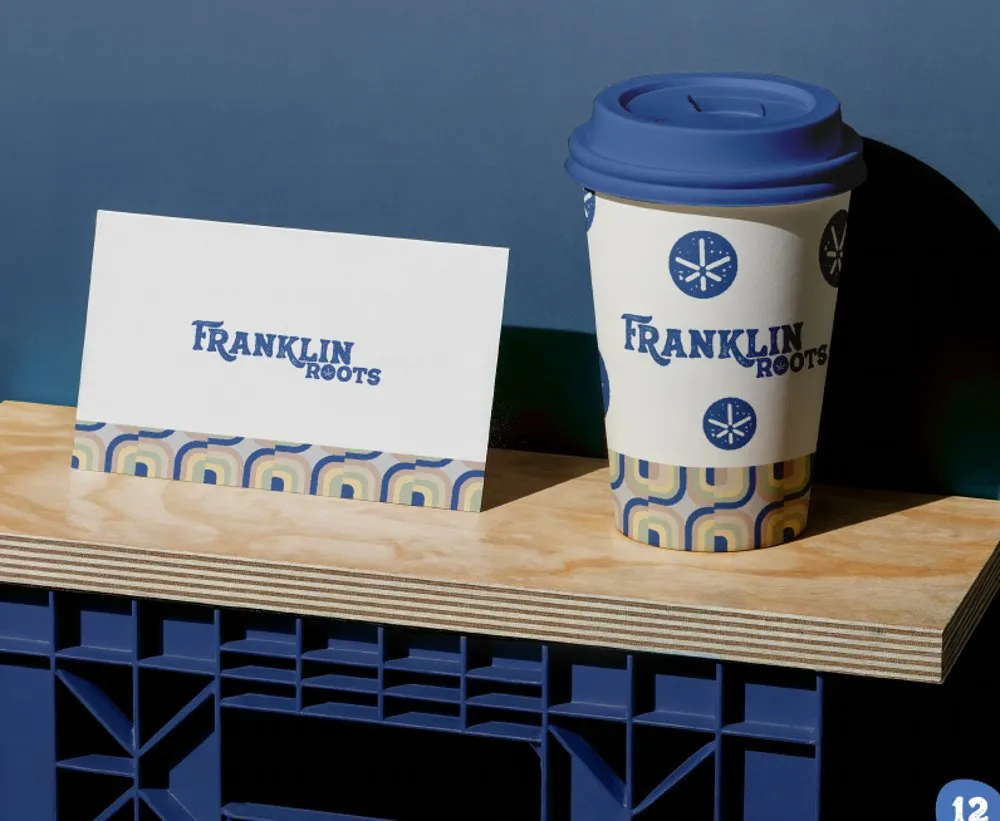 Franklin Roots branded coffee cup and business card showing brand details